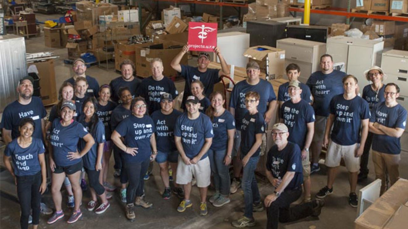 The BrandExtract team standing in the Project C.U.R.E. warehouse.