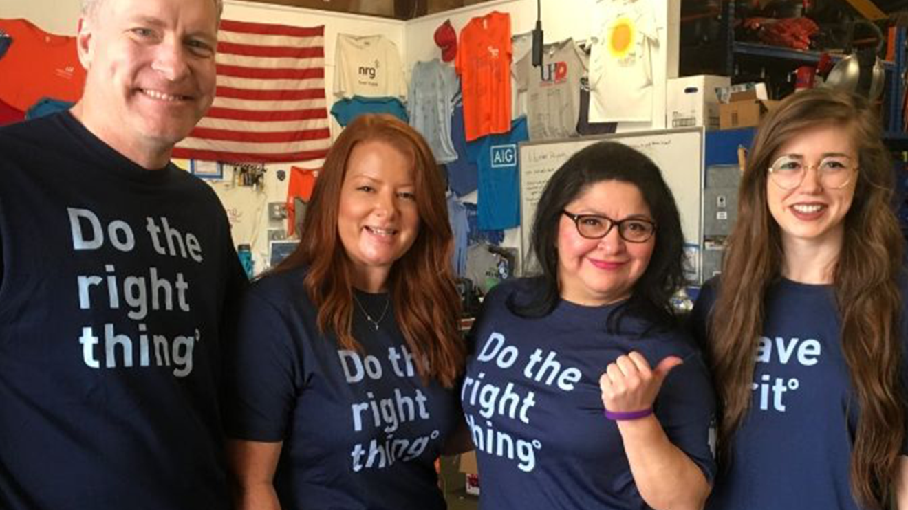 Four BE team members posing in their "Do the Right Thing" shirts at the Houston Community ToolBank.