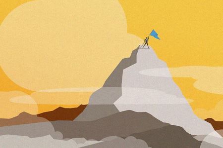 Man holding a flag on top of a mountain