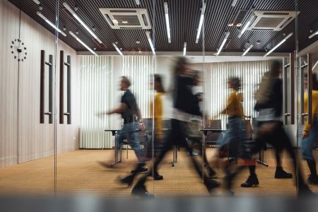 Group of blurry people walking in a building