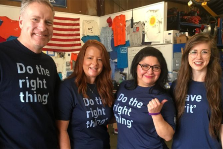 Four BE team members posing in their "Do the Right Thing" shirts at the Houston Community ToolBank.