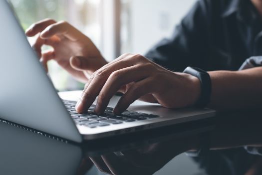 Man typing on a laptop