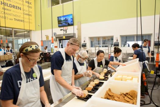 A picture of Julia packing food at the Houston Food Bank.