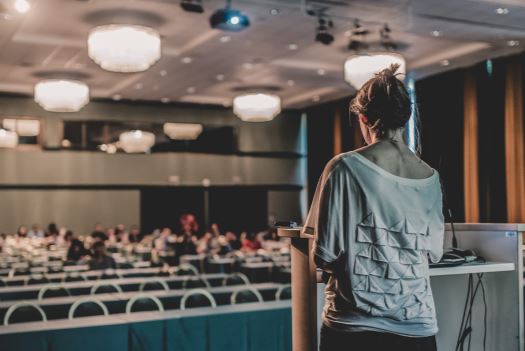 Backshot of a woman giving a presentation