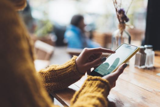 Woman holding an iPhone X