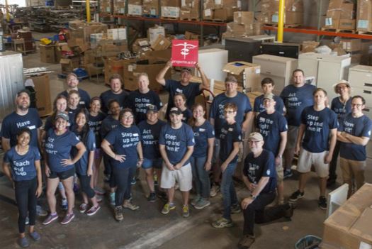 The BrandExtract team standing in the Project C.U.R.E. warehouse.