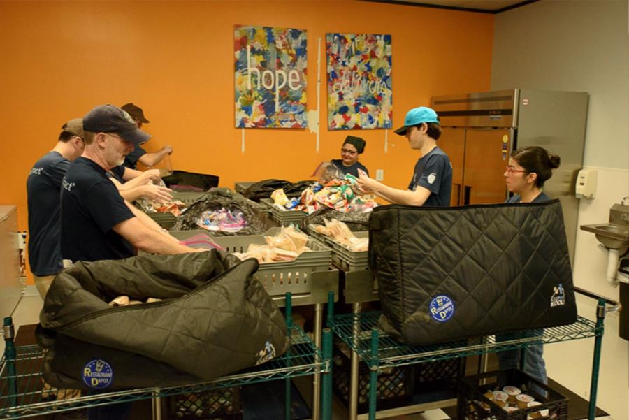 The BrandExtract team making sandwiches at Kids' Meals Inc. for impoverished children.