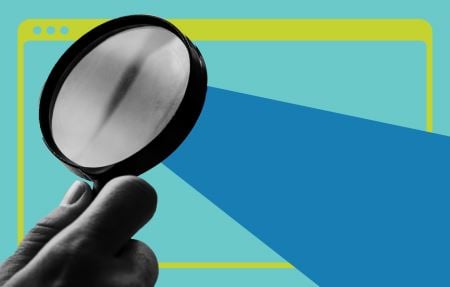 A hand holding magnifying glass over a browser window