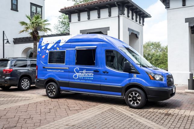 Photograph of a deep blue van labeled with the Southern Ice Cream logo in white cursive font