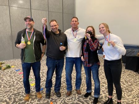 Jason, Malcolm, Bo, Rose and Lilli wearing gold medals after winning a company bowling competition