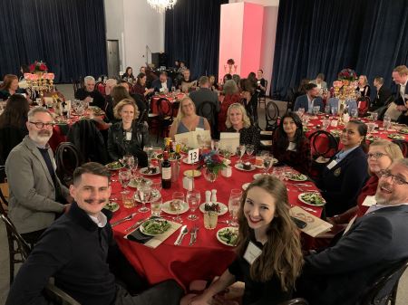 A group of ten BrandExtract employees sitting around a large round table at the Lantern Awards gala