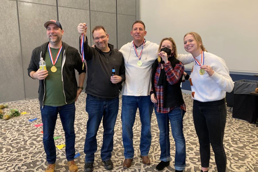 Jason, Malcolm, Bo, Rose and Lilli wearing gold medals after winning a company bowling competition