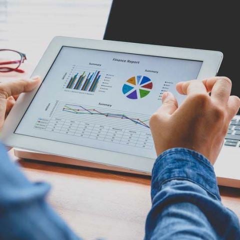 Man Looking at Customer Success Metrics on a Tablet