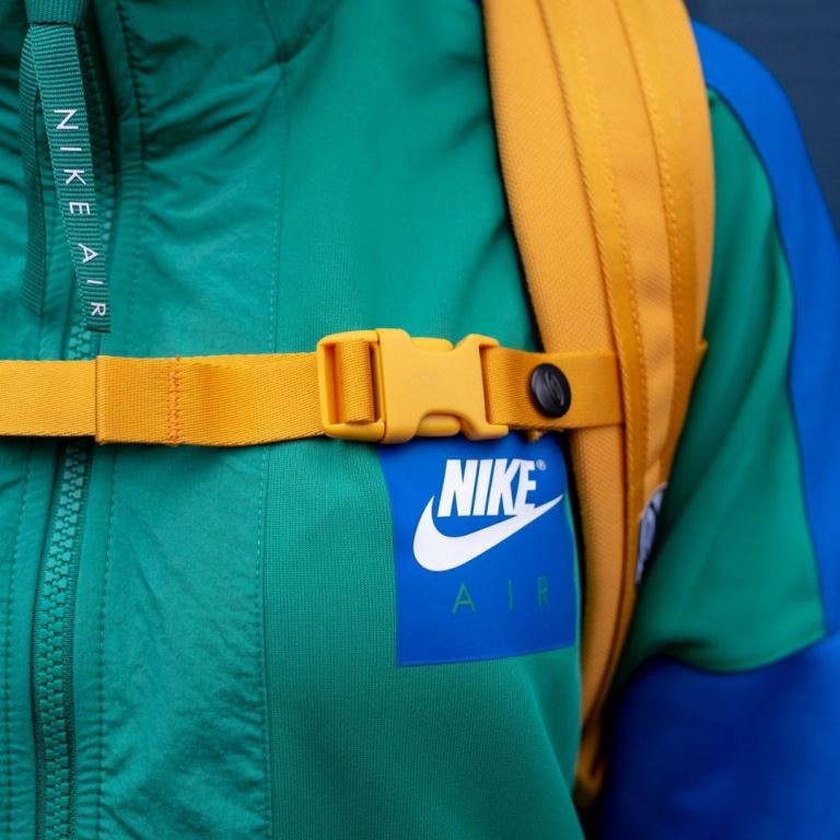 Man in Branded Jacket and Backpack