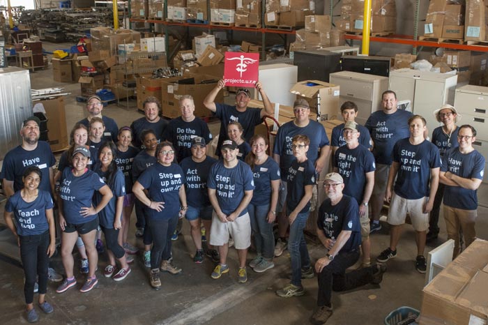 The BrandExtract team standing in the Project C.U.R.E. warehouse.