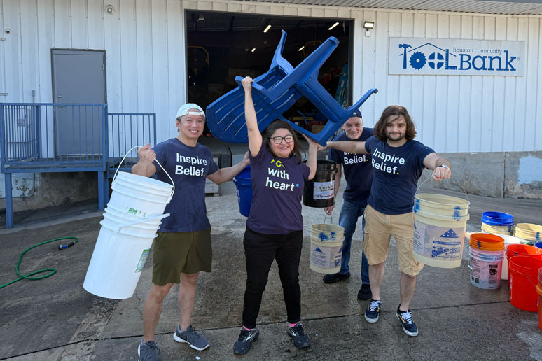 BE team carrying buckets and chairs at a volunteer event