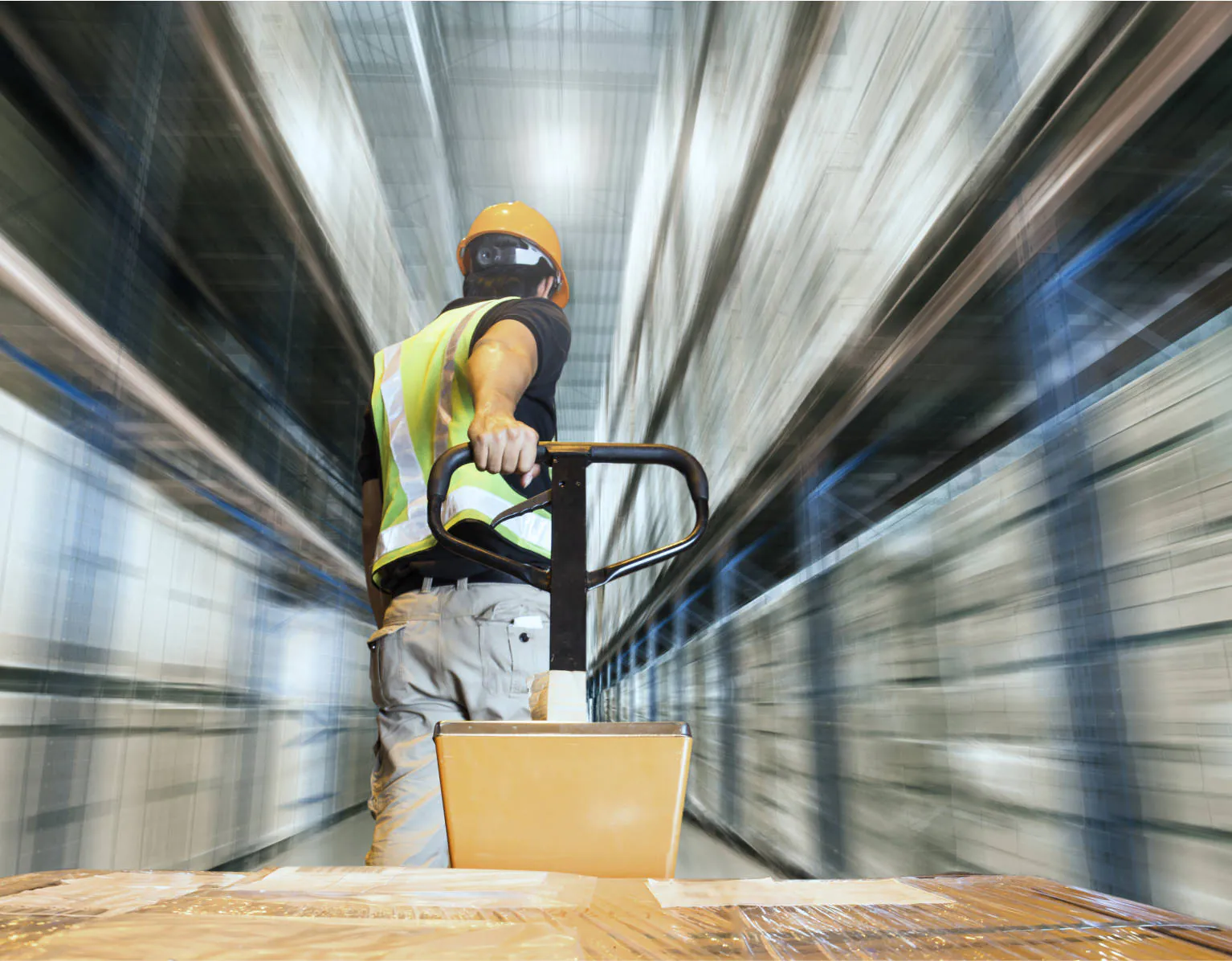 An Allredi warehouse worker pulling a cart with the world around him whizzing by