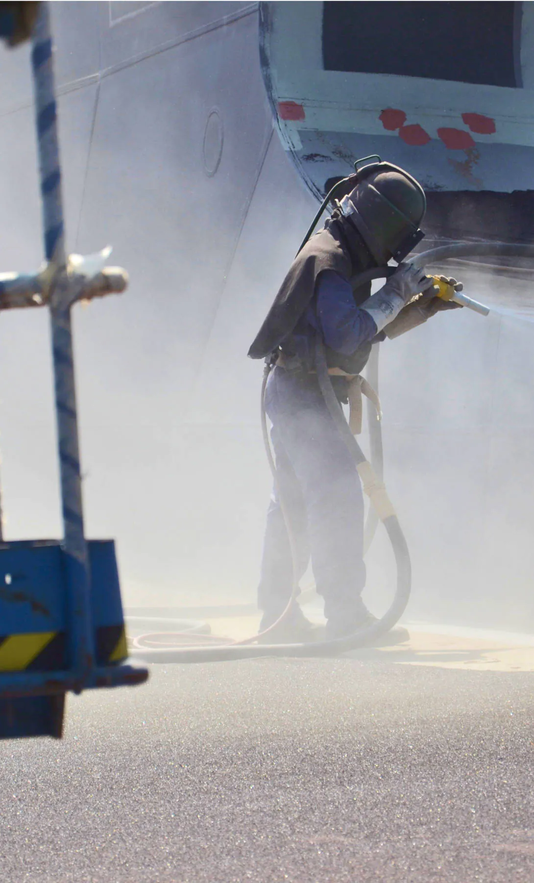 An Allredi employee power washing