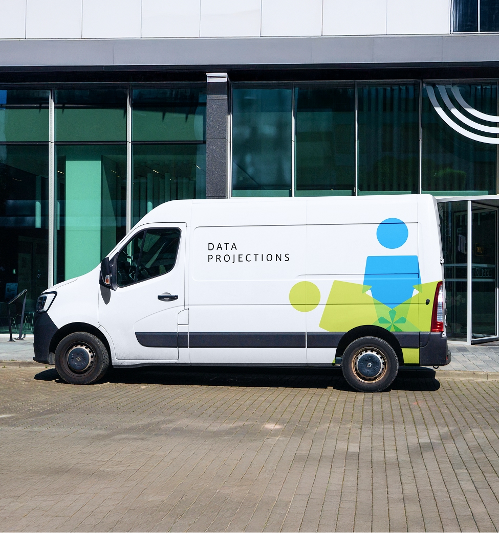 Data Projections branded white delivery van with human connectivity logo in blue and lime green parked outside modern glass office building