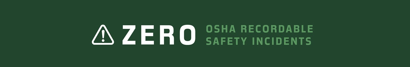 Banner reading &lsquo;Zero OSHA recordable safety incidents&rsquo; with a white warning icon on a dark green background.