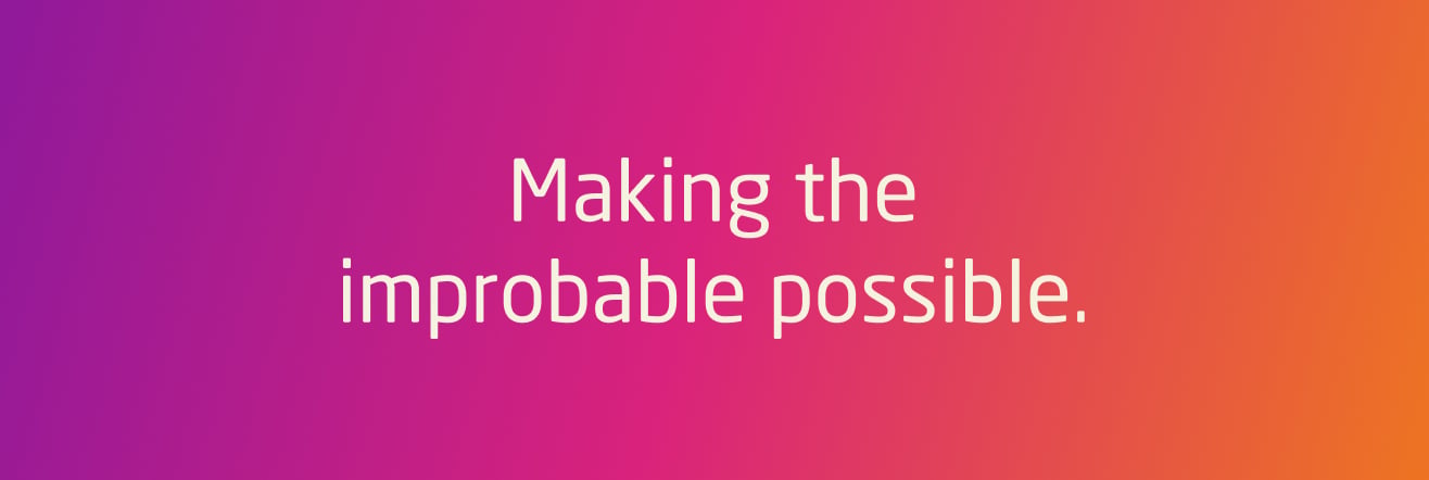 Gradient pink-to-orange background with white text reading ‘Making the improbable possible.
