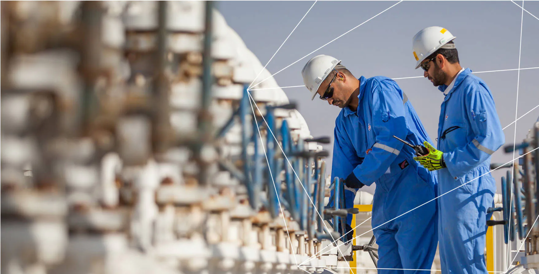Oxy workers checking tanks at a facility