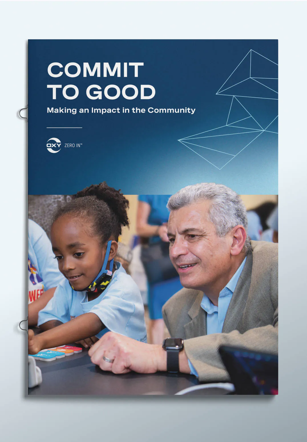 The cover of an Oxy pamplet titled "Commit to Good" featuring an Oxy employee teaching an elementary school girl