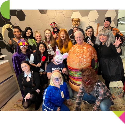 Small group of BrandExtract employees posing for a halloween photo wearing various costumes