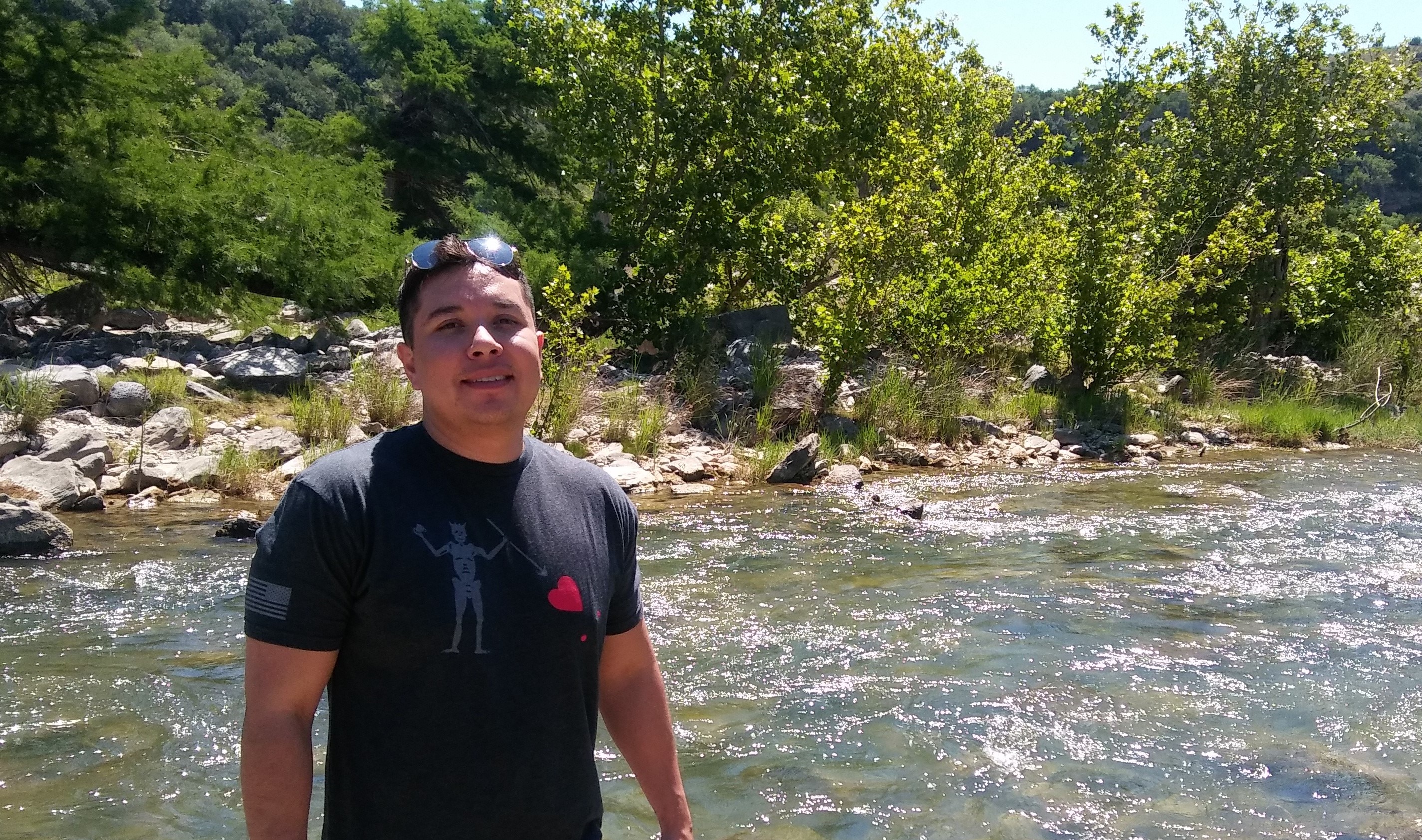 Edward standing in front of a creek at a state park