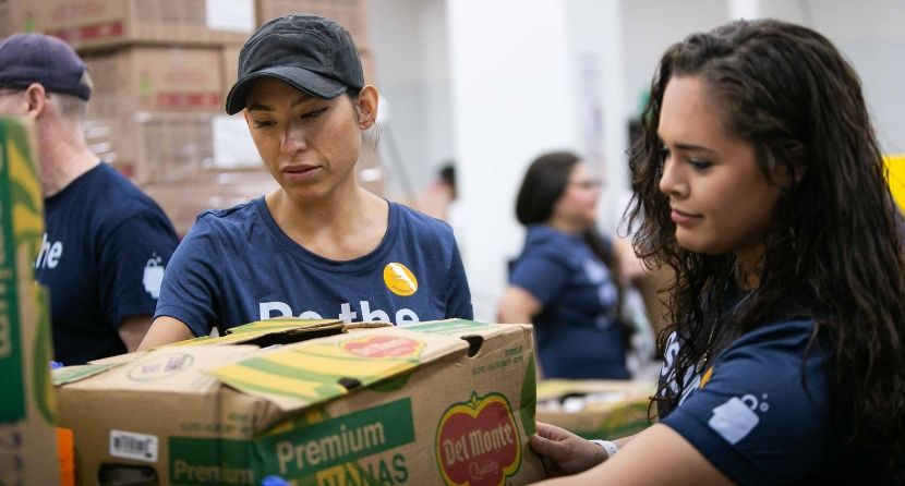 Marissa and Margo cart food at the Houston Food Bank.