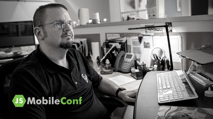 A black and white photo of John Laffite with the JSMobileConf logo.