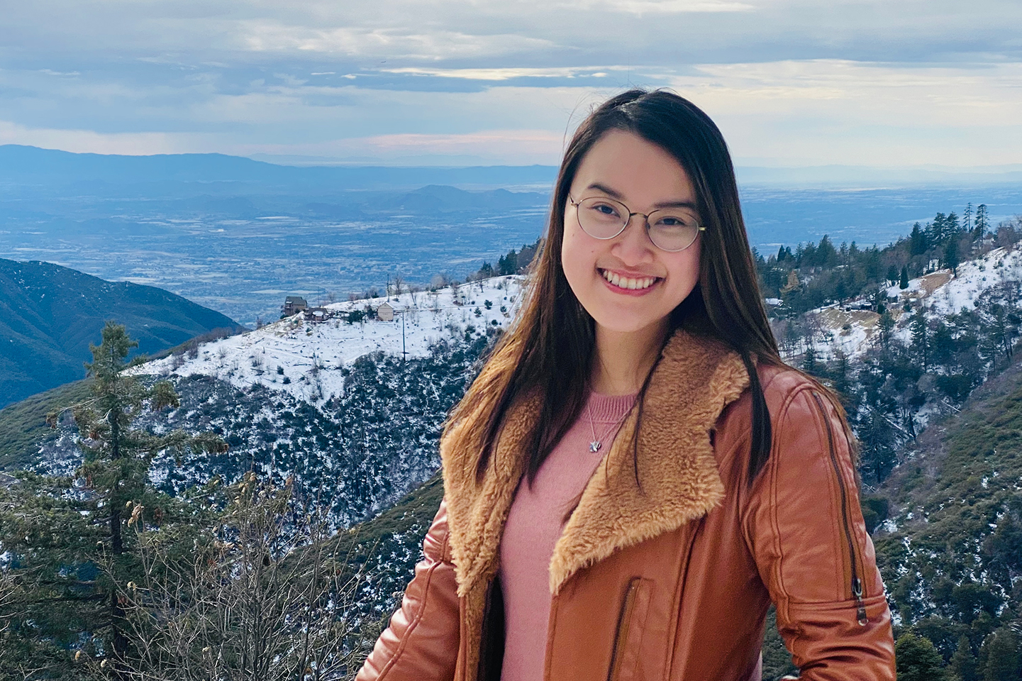 A picture of Nadia hiking in the mountains.