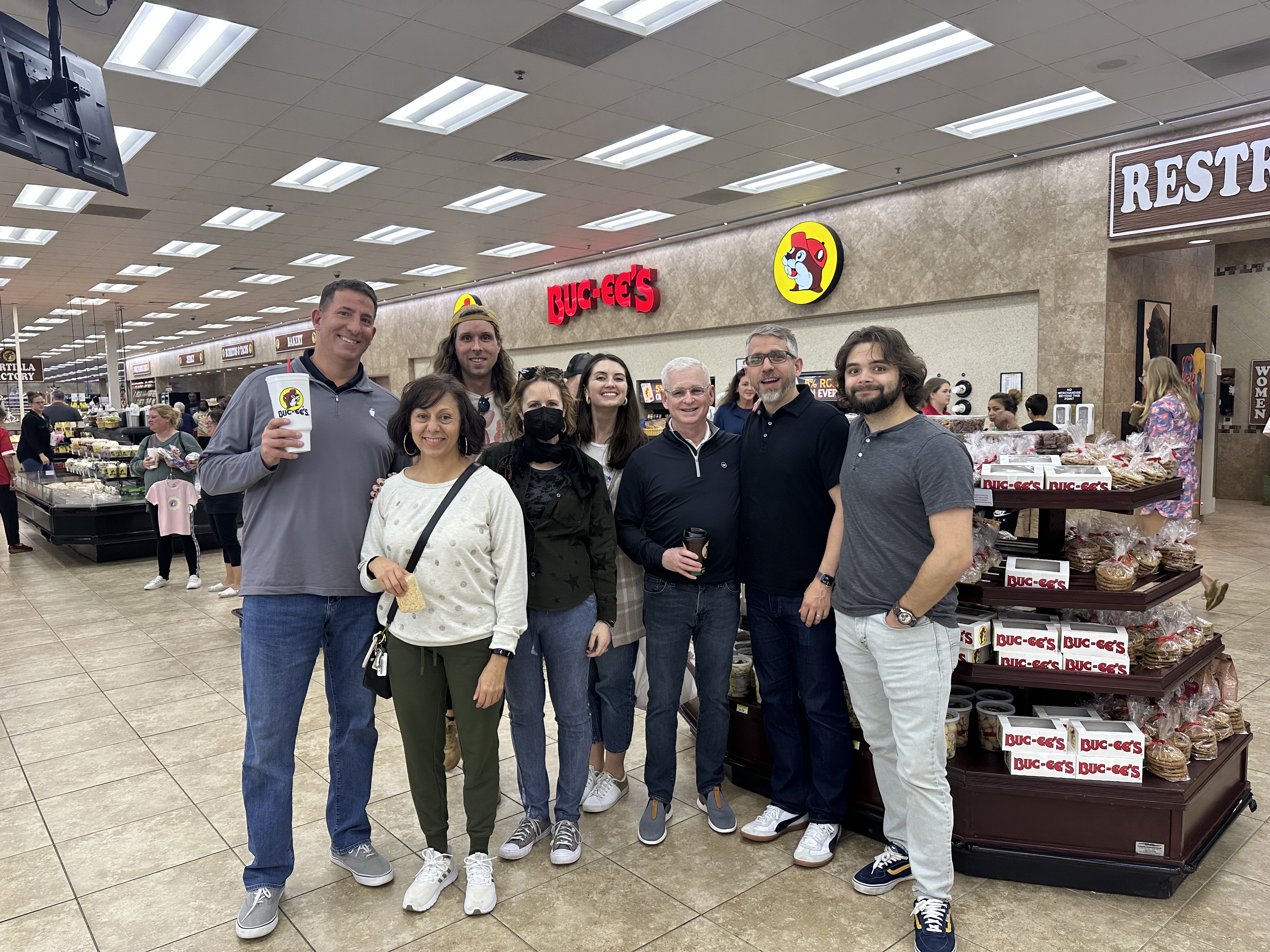 a group of BrandExtract team members posing for a photo inside a Buc-ee's convenience store