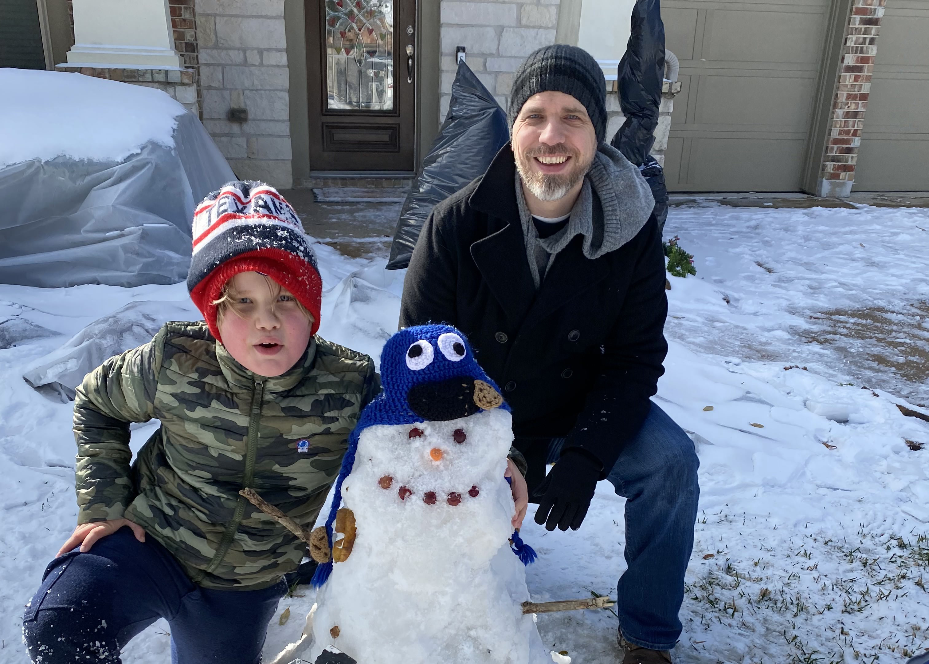 Jonathan making a snowman with his son