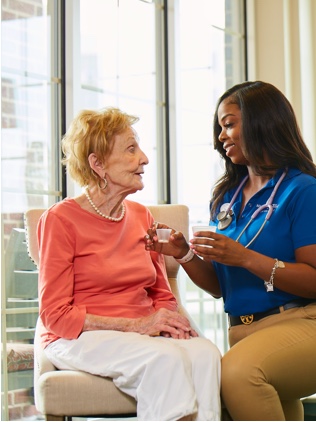 a Belmont Village employee taking care of a resident 