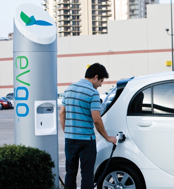 man charging his electric vehicle at an EVgo chargning terminal