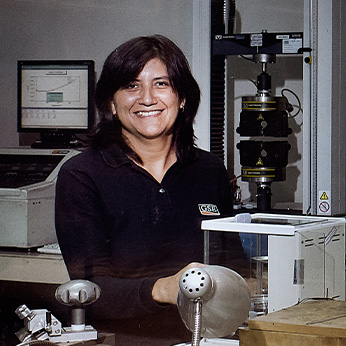 A female GSE employee in a lab smiling.