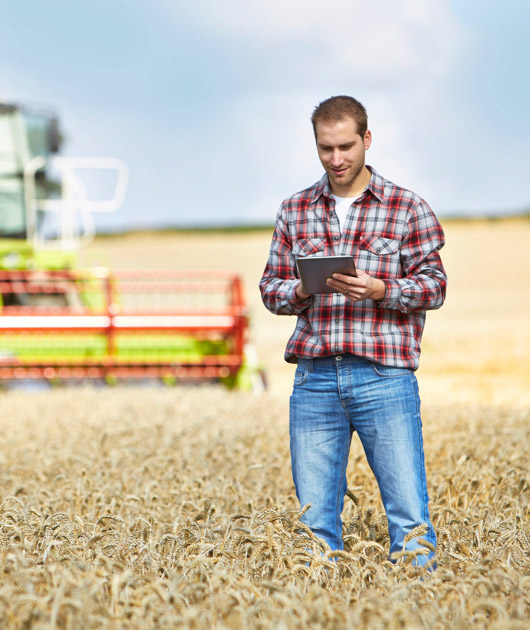 A man standing in a field using the pipeline finder app from MPC