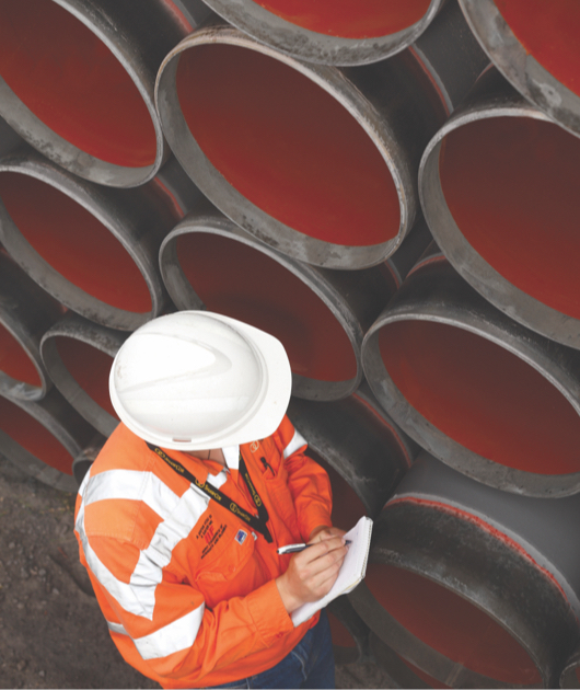 Man inspecting pipes on a job