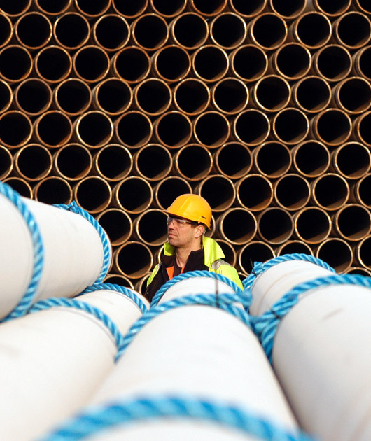 Man inspecting pipes at a work site 